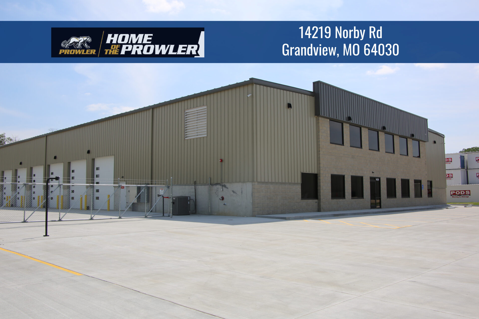 A large building with a metal roof and a black door.